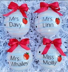 three glass ornaments with red bows on them and the words mrs and mr written on one ornament