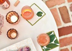 the table is set with candles, plates and napkins