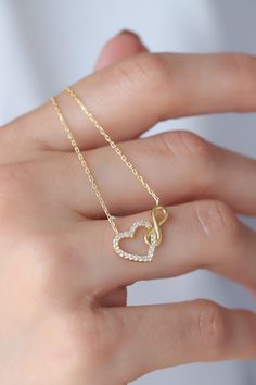 Love can be found even in the smallest details. This infinity heart necklace may seem like a small detail, but it definitely carries the biggest meaning. It is the most elegant representative of immortal love. DETAIL * Made to order. * 100% 14K Solid Gold * Gold Color Selection: Yellow Gold, Rose Gold, White Gold * Cubic zirconia * Pendant Lamp Height: 21 mm / 0.82 inch * Pendant Width: 12 mm / 0.47 inch * Length: 14", 16", 18", 20", 22" (I have a little note in the photos that may help you.) * Ready to Ship in 1-3 Business Days * 100% sourced from the USA * Free returns within 14 days from order date A B O U T ∙ U S * All customization is done by hand. Because it's better this way. * 100% Ethically Sourced, USA raw materials * Our beautiful packaging was created with love and fun on a mot Infinity-shaped Yellow Gold Jewelry Gift For Her, Infinity Yellow Gold Jewelry Gift For Her, Infinity Yellow Gold Jewelry As A Gift For Her, Yellow Gold Infinity Jewelry As Gift For Her, Anniversary Heart Necklace With Delicate Chain, Dainty Infinity Necklace As Gift For Her, Elegant 14k Gold Heart Necklace For Anniversary Gift, Elegant Open Heart Necklace With Adjustable Chain, Elegant 14k Gold Heart Necklace For Anniversary