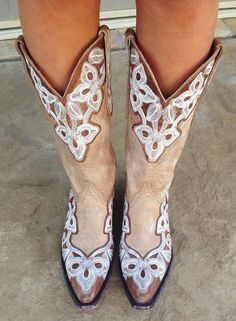 a close up of a person wearing cowboy boots