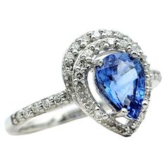 Ring Size: 7 This captivating blue pear-cut Ceylon sapphire ring is adorned with a halo of sparkling diamonds, all elegantly set in lustrous 18 karat white gold. The mesmerizing hue of the Ceylon sapphire is accentuated by the brilliance of the surrounding diamond halo, creating a stunning contrast that commands attention. Whether worn for formal or casual occasions, this ring is sure to elevate your style with the allure of this exquisite blue sapphire and diamond ring. This exquisite piece exu Halo Ring Set, Ceylon Sapphire Ring, Halo Ring Setting, Ceylon Sapphire, Sapphire Color, Halo Diamond Ring, Fine Jewelry Collection, Halo Ring, Diamond Halo