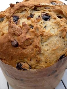 a loaf of bread with raisins and chocolate chips in it on a cooling rack