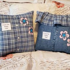 two blue pillows with pink flowers on them