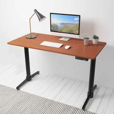 a computer desk with a monitor, keyboard and mouse sitting on it's side