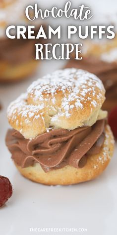 a chocolate cream puffs recipe with powdered sugar on top and raspberries in the background