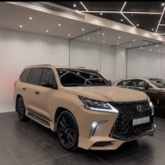 two cars are parked in a showroom