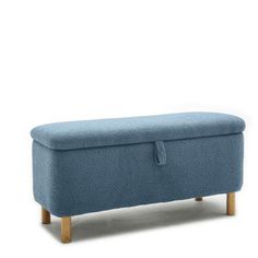 an upholstered blue bench with wooden legs