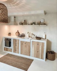 a kitchen with white walls and wooden cabinetry next to a rug on the floor