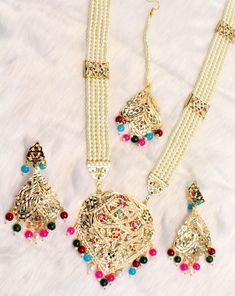 Jadau navrattan Rani Haar necklace Set embellished with pearls. Necklace length: 13 inches (including pendant) Earrings length: 2.9 inches (with drops) ; Width: 1.3 inches Rani Haar Long Necklaces, Nath Bridal, Bridal Pakistani, Pakistani Jewellery, Long Necklace Set, Indian Choker Necklace, Multicolor Necklace, Rani Haar, Indian Nose Ring