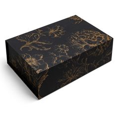 a black box with gold floral designs on the front and sides, sitting on a white surface