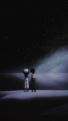 two people standing in the dark looking at the stars