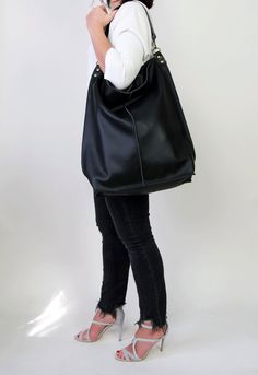 Black leather hobo This black large tote bag is made from high quality italian leather. Spacious interior provides room for all the daily essentials and more. There is an inside zippered pocket. This bag is perfect as your everyday bag, which can fit an IPAD, laptop, A4 files, books, magazines, cosmetic bag as well as many accessories. This bag has top zipper closure for safety. Height: 18,5 inch (47 cm) Width: 18,1 inch (46 cm) Length of handle: 19,3 inch (49 cm) Bottom width: 13,4x 5,5 inch (3 Black Hobo Bucket Bag For Shopping, Black Hobo Bag With Leather Handles For Errands, Black Hobo Satchel For Errands, Versatile Black Hobo Bag, Everyday Large Capacity Black Hobo Bag, Black Soft Leather Hobo Shoulder Bag, Everyday Black Hobo Bag, Black Hobo Bag With Large Capacity, Black Hobo Bag With Removable Pouch