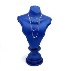 a blue mannequin with two necklaces on it's neck and a white background