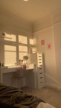 a bedroom with a bed, desk and shelves on the wall next to each other