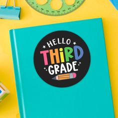 a book with the words hello fifth grade on it next to school supplies and scissors