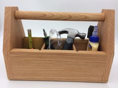 a wooden tool caddy with tools in it