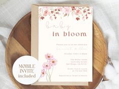 a baby in bloom shower is shown on a wooden plate with cotton swabs