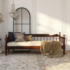 a living room with a couch, rug and chandelier hanging from the ceiling