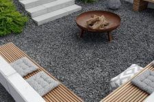 an aerial view of a patio with seating and fire pit