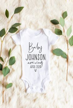 a baby bodysuit with the words desert babe on it next to some green leaves