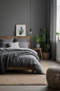 a bedroom with grey walls and wooden bed frame, plants on the floor, and rugs