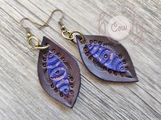 These boho genuine leather tribal drop earrings are a stylish choice for both casual and dressed-up looks.  Handmade with excellent quality leather, the unique brown and blue design adds a timeless accent to your outfit, perfect for any occasion, from parties to festivals. Approximate Dimensions: Length 2 in / 5 cm Width 0.9 in / 2.5 cm Bohemian Leather Earrings, Brown Bohemian Dangle Earrings, Bohemian Blue Leather Earrings, Blue Bohemian Leather Earrings, Blue Leather Bohemian Earrings, Bohemian Leather Drop Earrings, Bohemian Teardrop Leather Earrings, Bohemian Leather Teardrop Earrings, Rustic Brown Hand-tooled Earrings