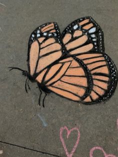 a drawing of two butterflies sitting on the ground with hearts drawn in front of them