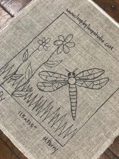 a cross stitch pattern with dragonflies on it