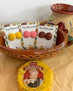 a bowl filled with cookies and cards on top of a table