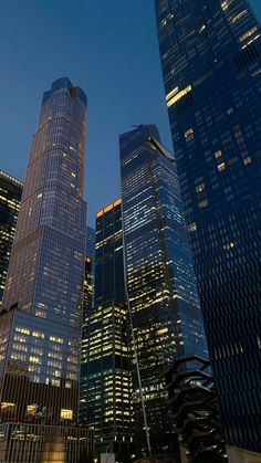 skyscrapers lit up at night in the city