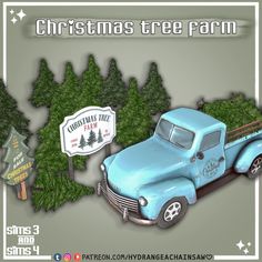 an old blue truck is parked in front of some trees and a christmas tree farm sign