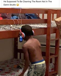 a young boy standing in front of a bunk bed with headphones on his ears