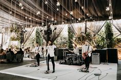 a group of people standing on top of a stage next to each other in front of a crowd