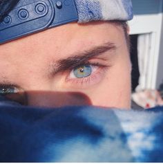 a close up of a person's eye with a head band on top of his head