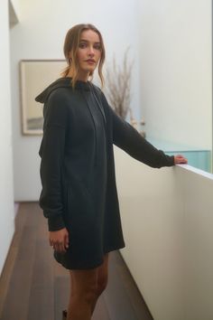 A person stands in a hallway wearing the ETTA HOODIE DRESS from Velvet by Graham & Spencer Fitted Sweatshirt Dress, Hoodie Dress Outfit, Velvet Tees, Cami Shirt, Workout Sweatshirt, Sweater Sale, Romper Dress, Cotton Fleece, Sweatshirt Dress