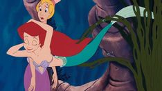 the little mermaid is holding on to her mother's back in front of an underwater scene