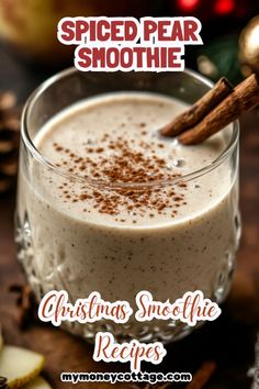 a glass cup filled with christmas smoothie and cinnamon sticks on top of the mug