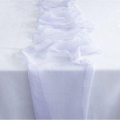 a white table cloth with ruffles on it