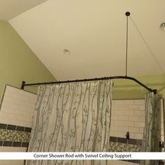 a bathroom with green walls and white tile on the ceiling, shower curtain is open