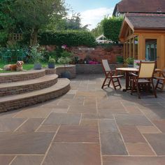 an outdoor patio with stone steps and seating area