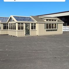 an empty parking lot with three buildings and the words, how much does it cost?