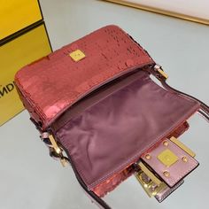 SHOP MORE LUXURY PRODUCTS HERE Description Fendi Mini Baguette 1997 Pink Sequinned Bag For Woman 19.5cm/7.5in 8BS049AISLF1H37 Size: 19.5 x 5 x 11 cm / 7.5 x 2 x 4.5 inch Mini 1997 Baguette bag with all-over pink metallic sequin embroidery, embellished with an FF clasp.This style is a re-release of the first Fendi Baguette, created in 1997, from which it takes its name and the iconic design to wear under the arm.Featuring a front flap, rose-gold leather details and a magnetic clasp. Satin-lined i Luxury Baguette Bag With Detachable Strap, Designer Pink Baguette Bag With Detachable Strap, Designer Pink Baguette Bag With Detachable Handle, Pink Baguette Bag With Gold-tone Hardware For Evening, Pink Evening Baguette Bag With Gold-tone Hardware, Luxury Baguette Bag With Detachable Handle For Party, Luxury Baguette Shoulder Bag For Party, Designer Rectangular Baguette Bag For Party, Luxury Baguette Bag For Party