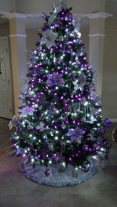 a christmas tree with purple and silver decorations