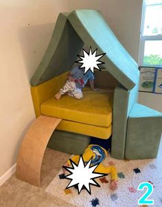 a child is sitting in a green and yellow chair with a ramp to the side