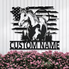 a metal sign with a horse and the words custom name in front of some flowers