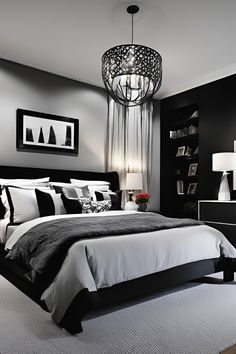 a black and white bedroom with a chandelier hanging from the ceiling, two lamps on either side of the bed