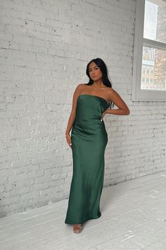 This Emerald Green Maxi Dress will make you feel elegant and special. Crafted from luxuriously smooth satin silky, the dress features a strapless silhouette with a cowl back and a waisted tie. The long length flatters any figure and makes this dress perfect for a formal occasion. emerald green strapless dramatic cowl back back bow tie relaxed fit long length 100% polyester model is wearing a small Green Strapless Dress With Straight Neckline For Evening, Evening Green Midi Dress With Straight Neckline, Elegant Green Slip Dress With Straight Neckline, Satin Backless Midi Dress For Prom, Satin Floor-length Slip Dress For Date Night, Green Straight Neckline Midi Dress For Evening, Floor-length Satin Slip Dress For Date Night, Green Midi Dress With Straight Neckline For Evening, Green Prom Dress With Straight Neckline