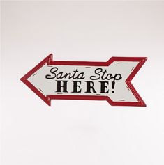 a red and white sign that says santa stop here