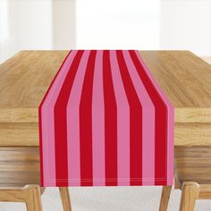 a red and white striped table cover sitting on top of a wooden table