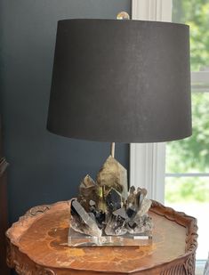 a table with a lamp and some rocks on it